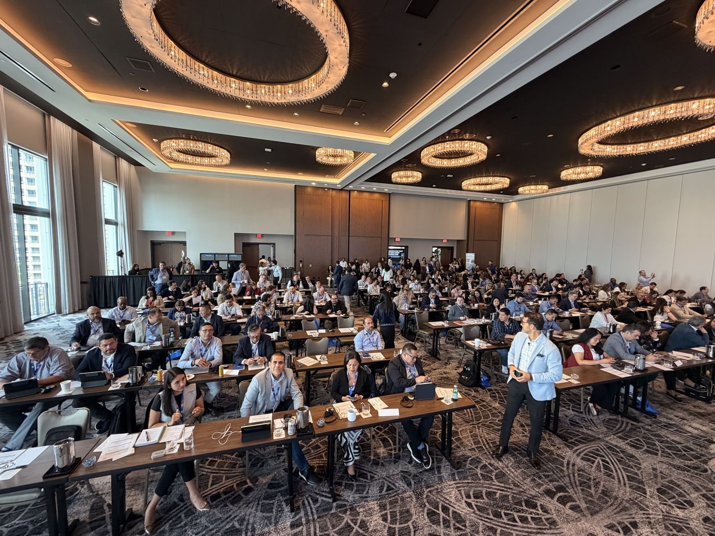 Conference attendees seated at tables during a corporate summit