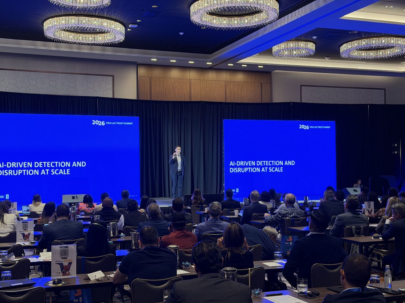 Corporate conference coverage, speaker on stage