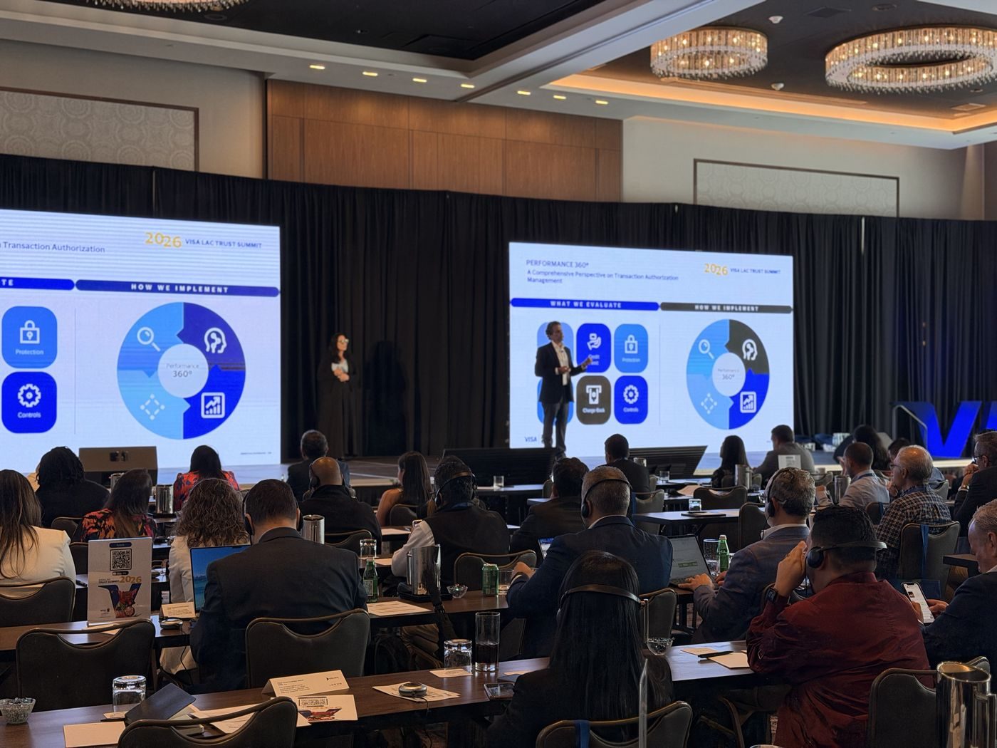 Speaker presenting to seated attendees at a corporate summit