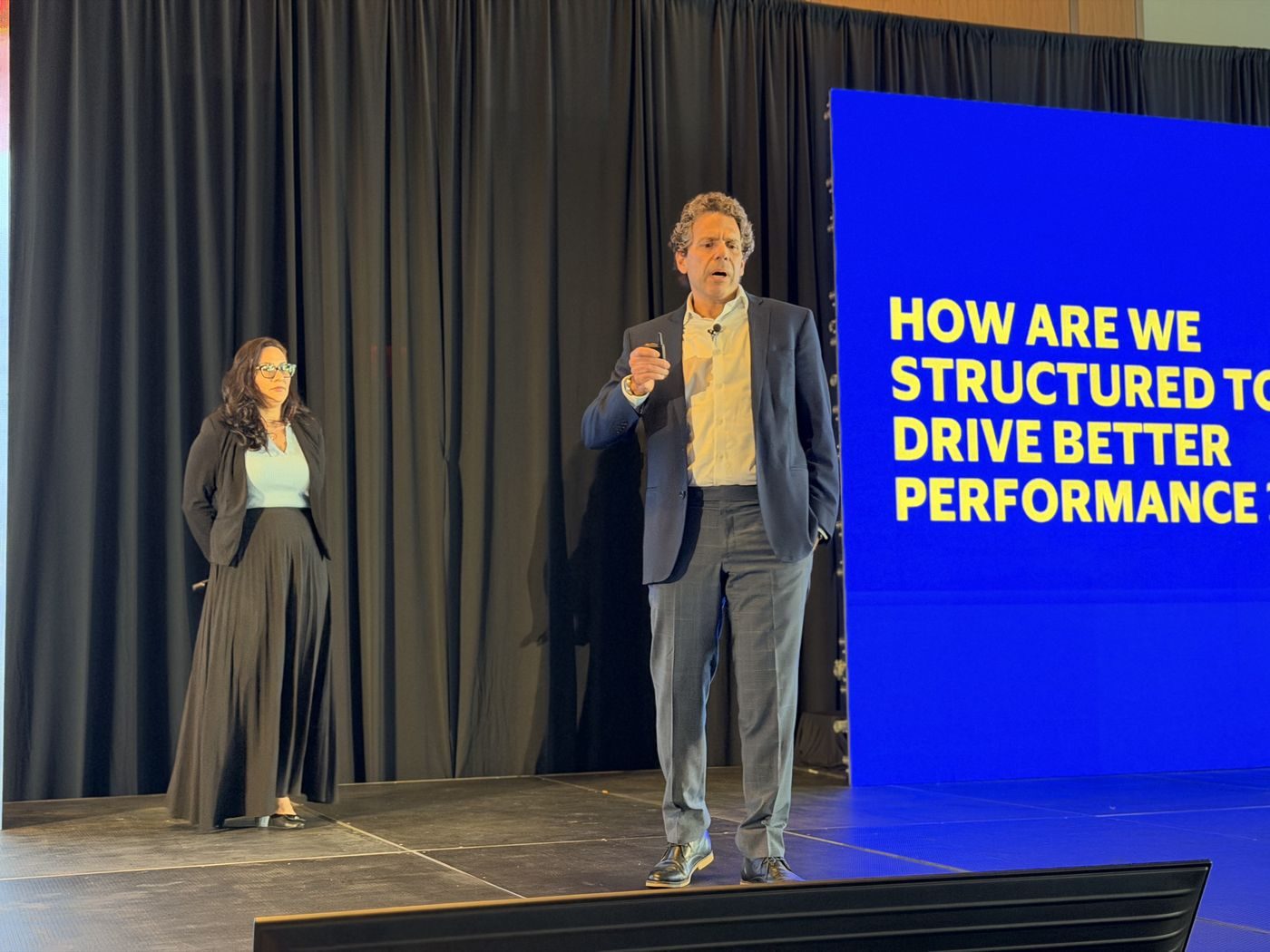 Keynote speakers on stage at a corporate conference