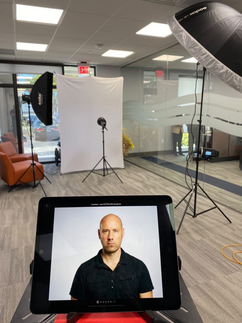Tablet showing a just-taken office headshot preview during a team headshot day