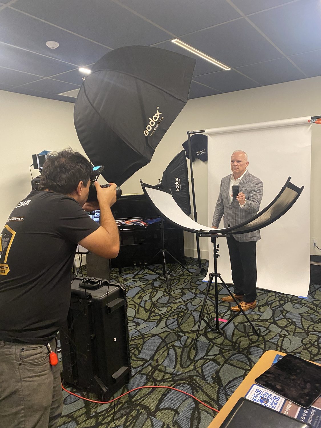 BLINK photographer directing a guest at an on-site event headshot station
