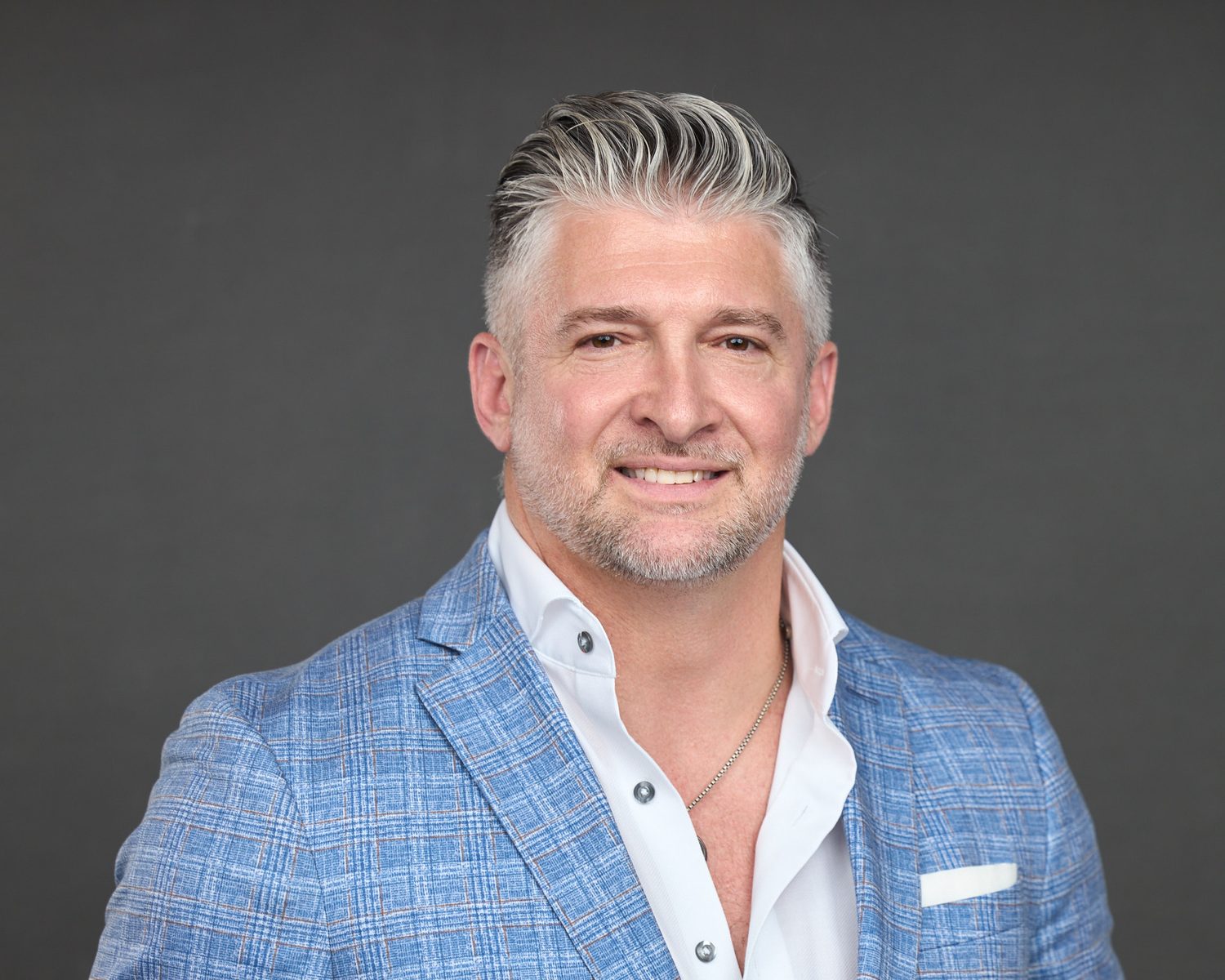 Corporate headshot of an executive photographed on site at his office