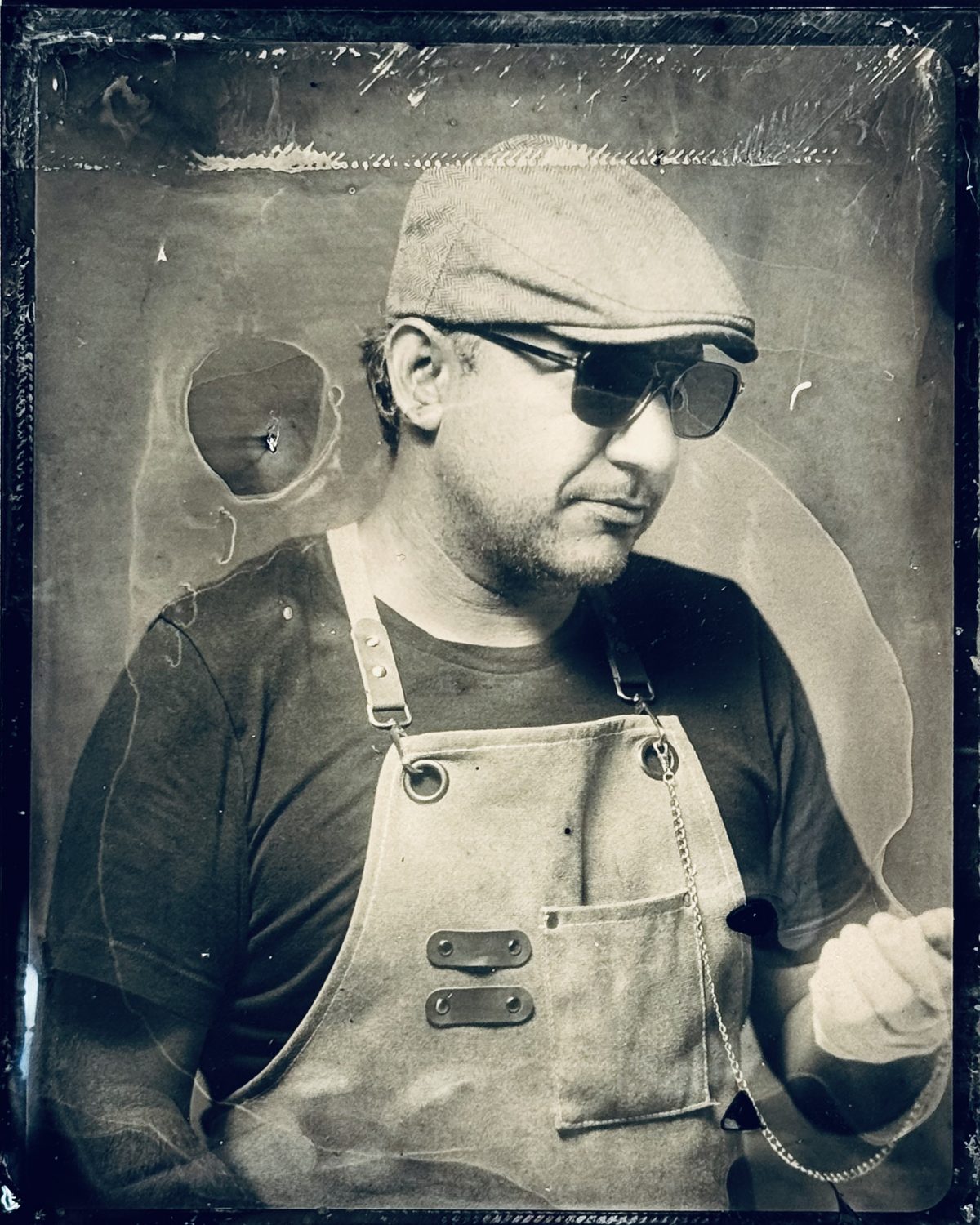 Julian Buitrago, photographer and tintype artist, in his darkroom apron
